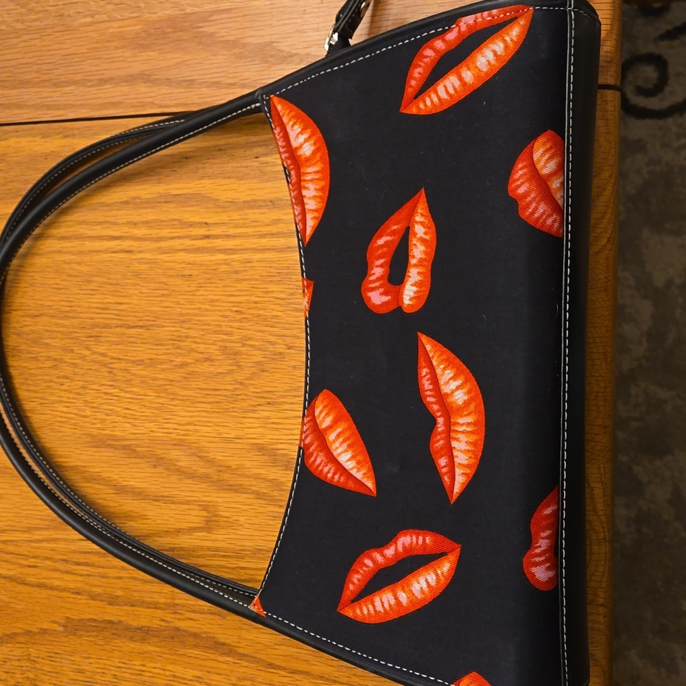 Black handbag with lips on it